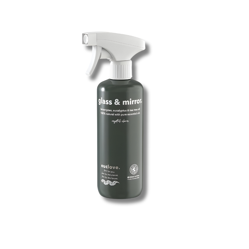 Green spray bottle with white nozzle on a white background