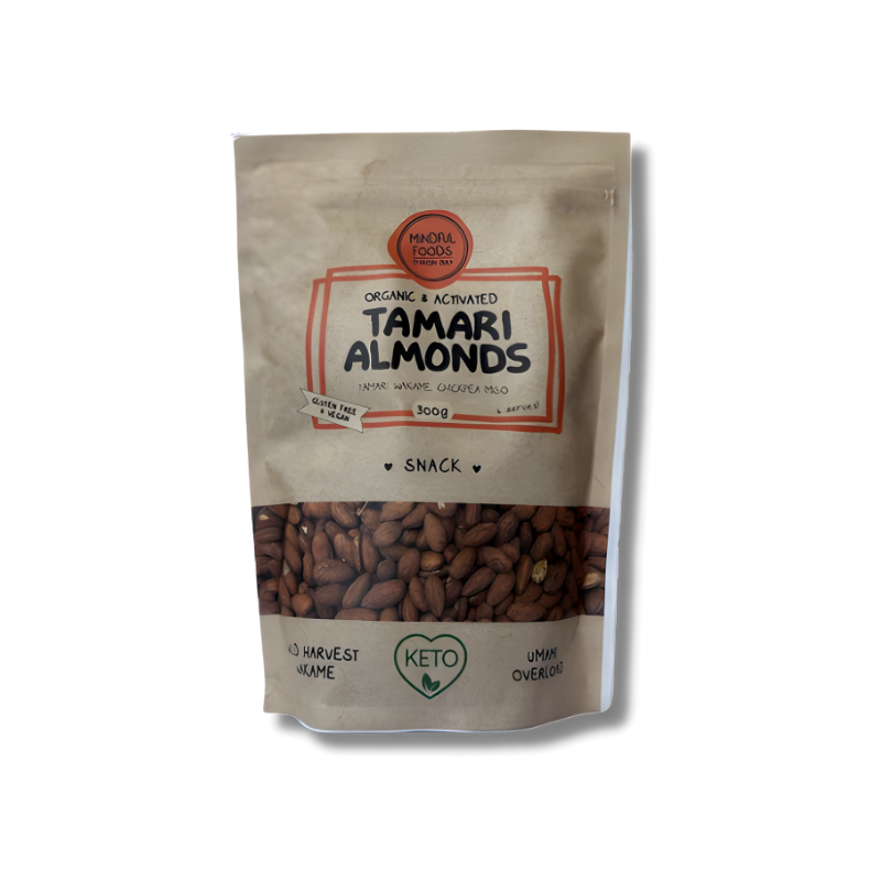 A resealable brown paper pack of Mindful Foods Tamari Almonds, showing golden-brown roasted almonds coated in tamari seasoning. The packaging has a clear window displaying the crunchy almonds inside, designed for healthy snacking.