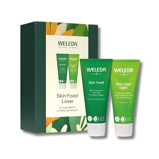 Two skincare products side by side, a bright green tube of Skin Food Original and a lighter green tube of Skin Food Light. Both creams are shown with rich, creamy textures, representing intensive hydration and nourishment for face and body.