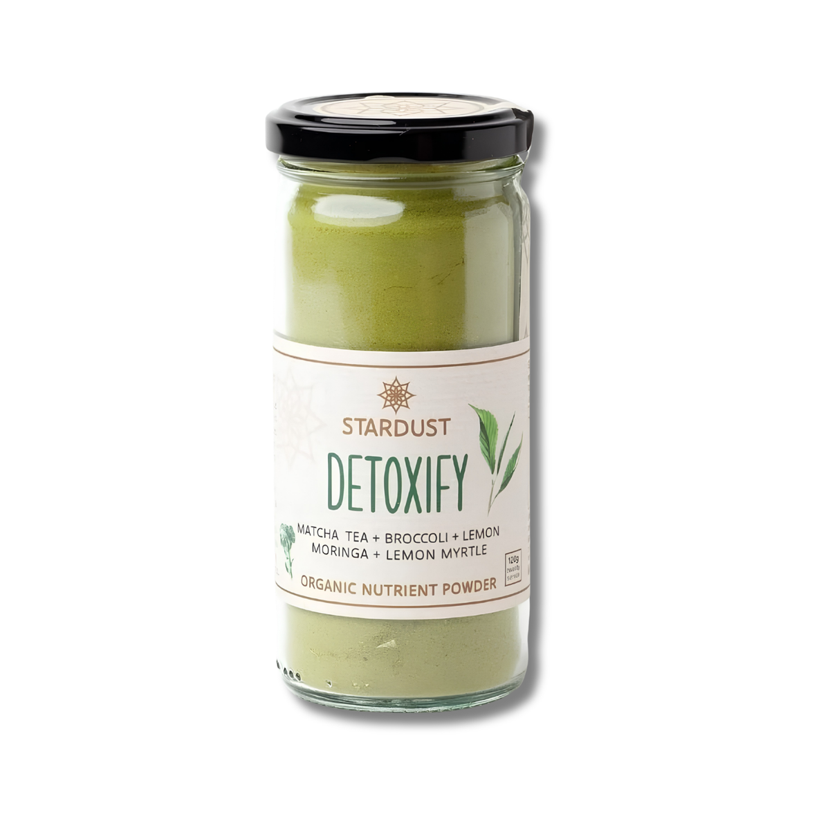 A glass jar of Stardust Detoxify organic nutrient powder, featuring a black lid and a cream-colored label with green text and leaf graphics, set against a plain white background.