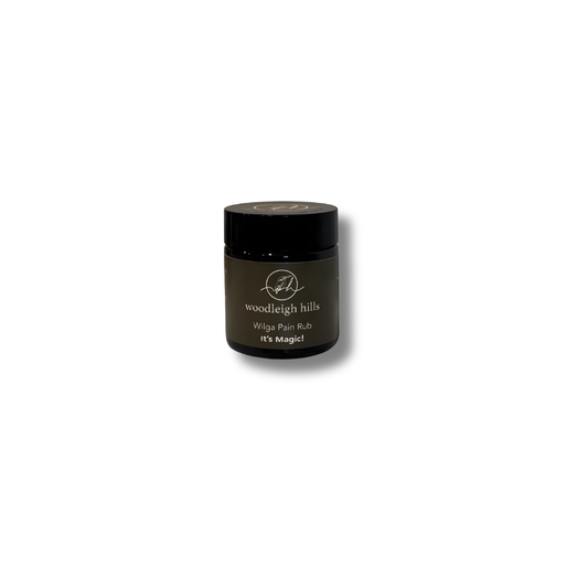 Green jar of Woodleigh Hills wilga pain rub on a white background.