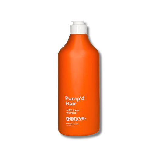 Orange shampoo bottle with white cap on a white background