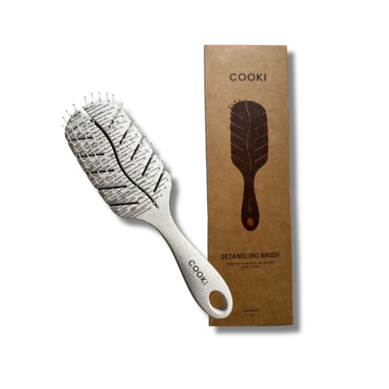 A single eco-friendly wheatstraw detangling brush with a smooth beige finish and curved handle, featuring soft recycled nylon bristles. The brush has a minimal, natural look designed for gentle, plastic-free hair care.