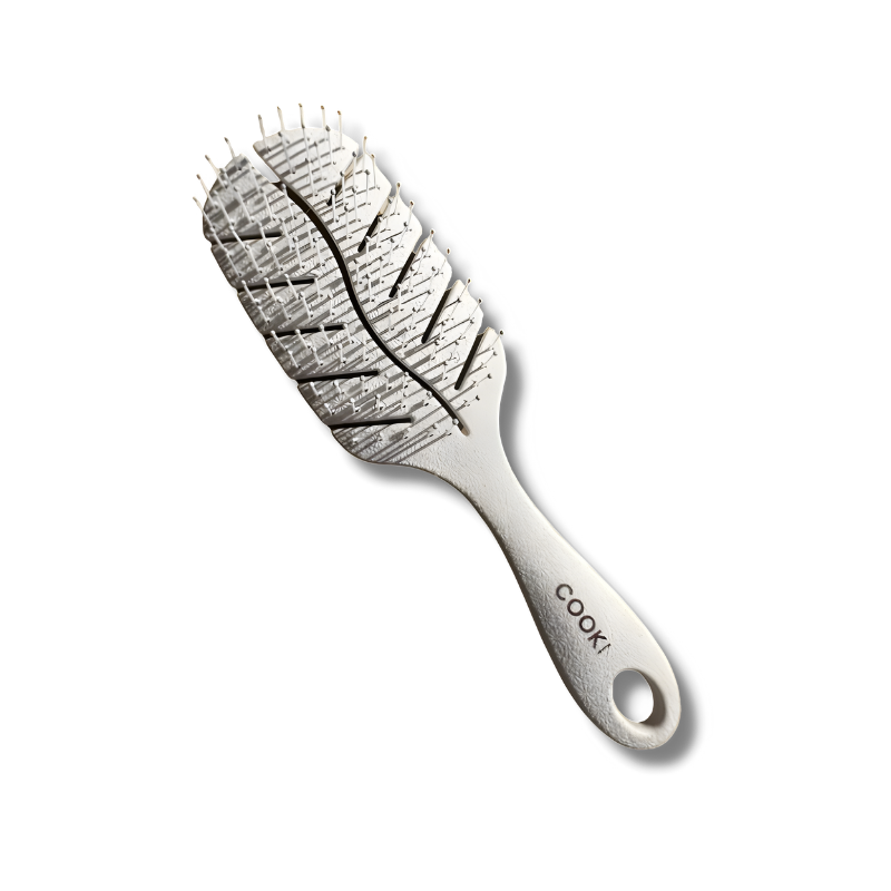 A single eco-friendly wheatstraw detangling brush with a smooth beige finish and curved handle, featuring soft recycled nylon bristles. The brush has a minimal, natural look  designed for gentle, plastic-free hair care.