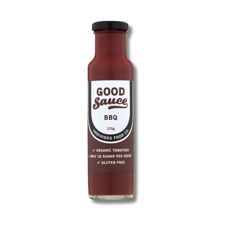 A bottle of Good Sauce BBQ sauce by Unidivided Food Co, featuring a dark reddish-brown sauce inside, a black cap, and a white label with brown text.