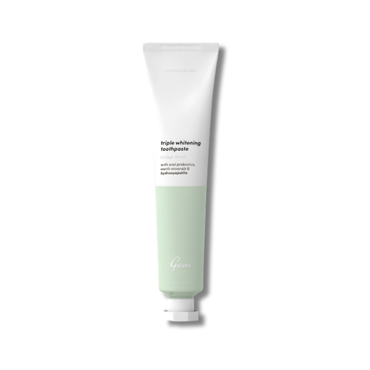 Tube of triple whitening toothpaste on a white background