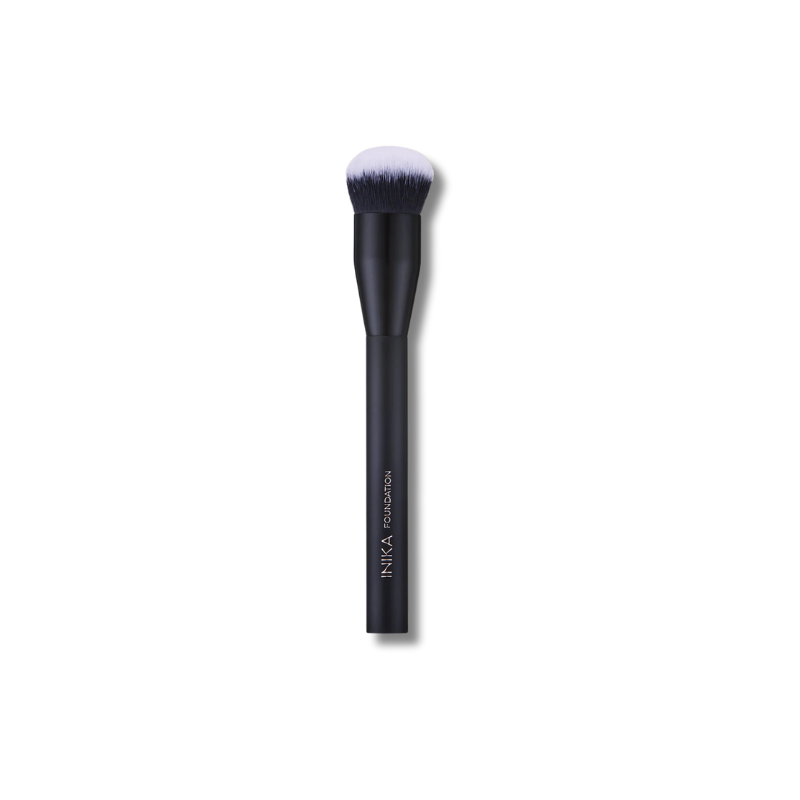 Black INIKA makeup brush with white bristle head on a white background