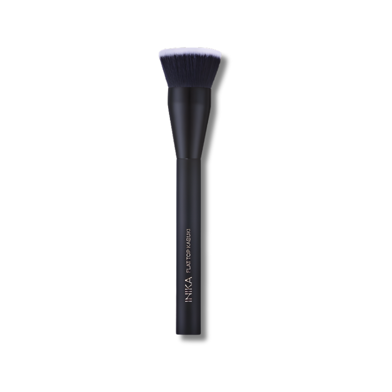 Black makeup brush with white bristles on a white background