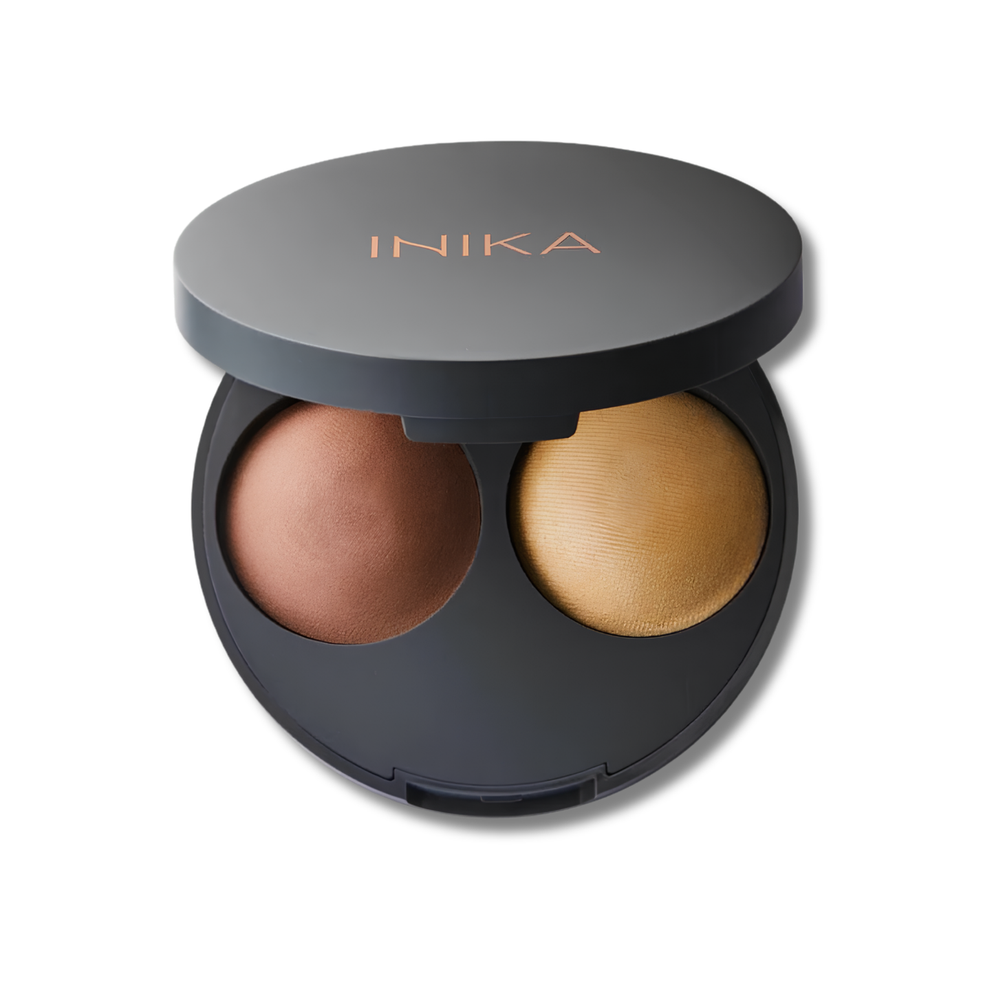 An open INIKA double-face powder compact on a white background, showing two pressed powders: a warm medium brown on the left and a light golden-beige on the right, housed in a matte black circular case.