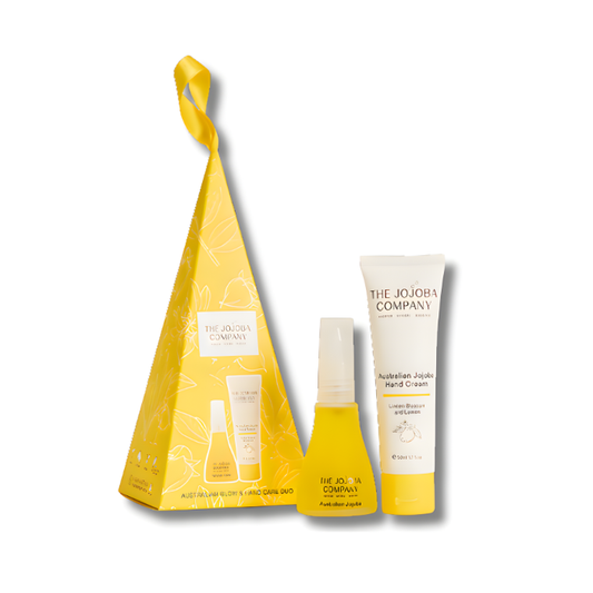 Two skincare products. The Jojoba Company’s Australian Jojoba Hand Cream and Australian Jojoba oil displayed side by side. The set is packaged in a soft, elegant design featuring golden and neutral tones, highlighting its premium, natural, and hydrating qualities.