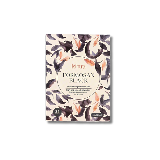 Kintra Formosan Black herbal tea packaging box, featuring a cream-colored background with a watercolor pattern of black and purple lotus flowers and peach-colored petals. The center has a circular beige label with the brand name 'kintra' and product name 'FORMOSAN BLACK'.