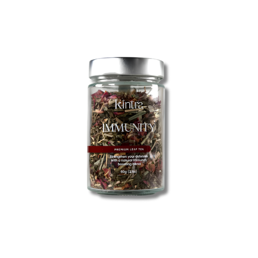 A glass jar of Kintra Immunity Premium Leaf Tea with a silver lid, containing a dried herbal blend, shown on a white background with a soft shadow.