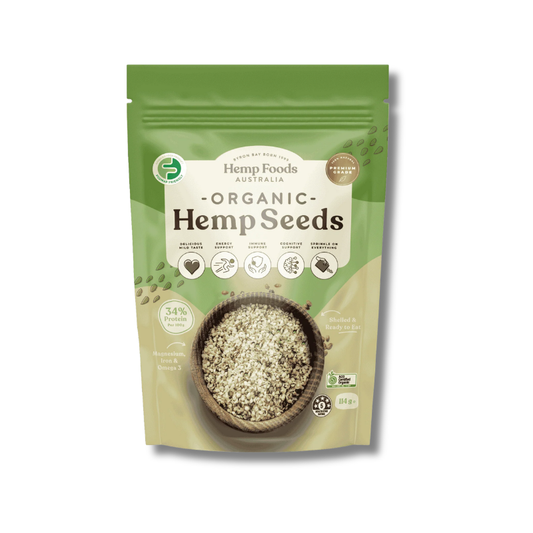 A 114g stand-up pouch of Hemp Foods Australia Organic Hemp Seeds, featuring a green and beige design with a bowl of hemp seeds on the front.