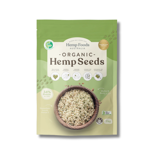 A 1kg stand-up pouch of Hemp Foods Australia Organic Hemp Seeds, featuring a green and beige design with a bowl of mixed hemp seeds on the front.