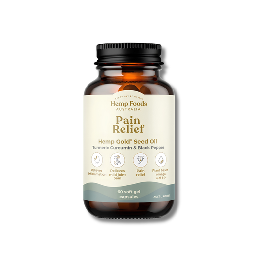 An amber glass bottle of Hemp Foods Australia Pain Relief Hemp Gold Seed Oil capsules, featuring a cream-colored label with green and brown text, and a black ribbed cap, set against a plain white background.