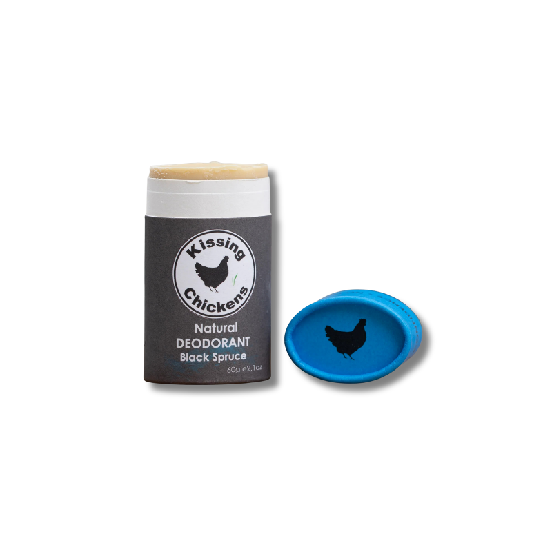 A stick of Kissing Chickens Natural Deodorant Black Spuce shown next to its blue cap on a plain white background.