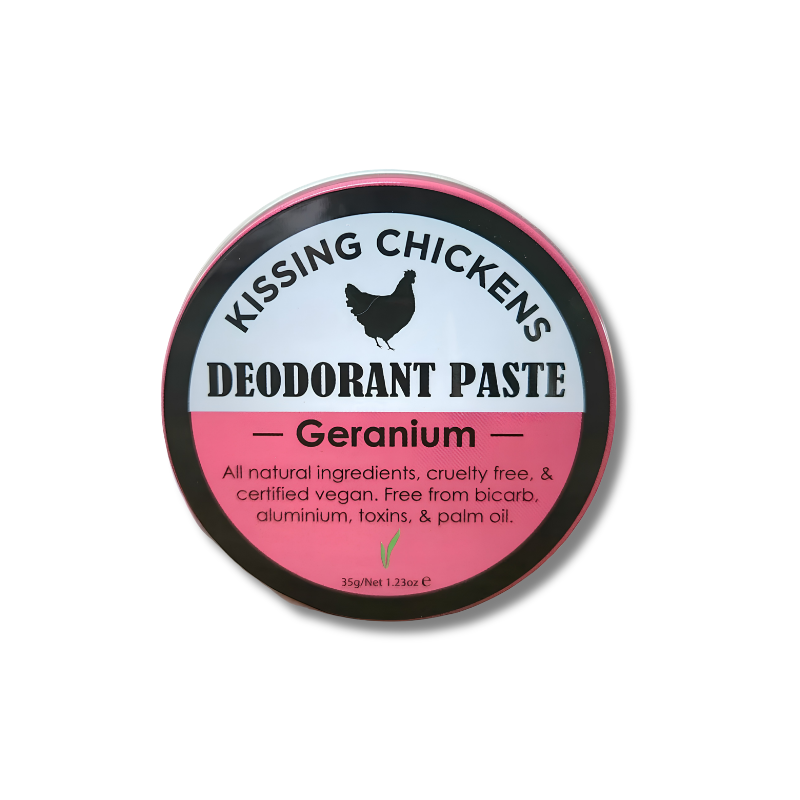 A round tin of Kissing Chickens Deodorant Paste in the Geranium scent, featuring a black, white, and pink label with a chicken silhouette.