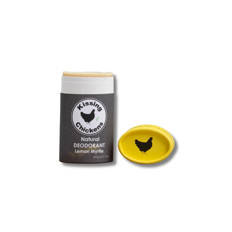 Kissing Chickens Natural Deodorant stick in Lemon Myrtle, shown with its dark gray container and a separate bright yellow cap on a white background.