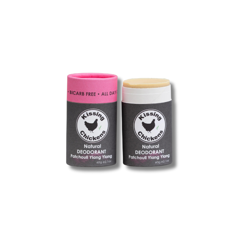 Two Kissing Chickens natural deodorant sticks on a white background. The left stick has a pink cap and the right stick has a white cap, both with dark gray labels featuring the Kissing Chickens logo.
