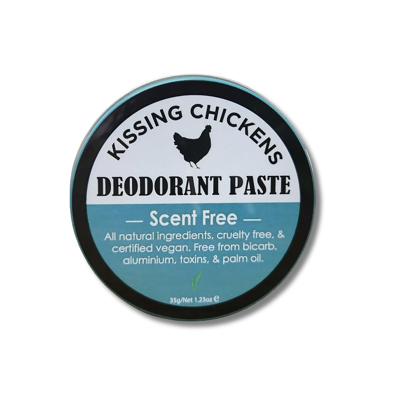 A round tin of Kissing Chickens Deodorant Paste on a white background. The label features a black outer ring, a white upper section with a black chicken silhouette and text, and a teal lower section with product details.