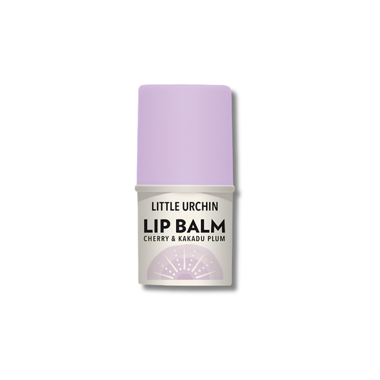 A single tube of Little Urchin Lip Balm in the Cherry & Kakadu Plum scent, featuring a light purple cap and a white label with black text, set against a plain white background.