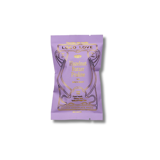 A single stand-up pouch of Loco Love Hazelnut Butter Praline flavor, featuring a light purple design with gold foil lettering and illustration, set against a plain white background.