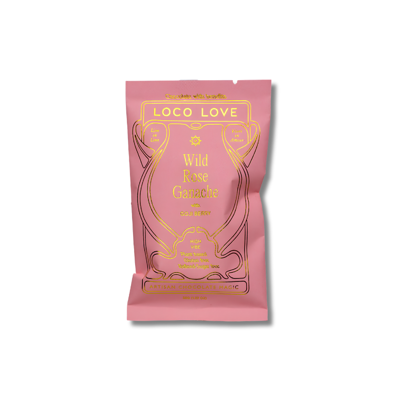 A pink pouch of Loco Love Wild Rose Ganache chocolate with gold foil lettering and decorative line art, shown on a plain white background.