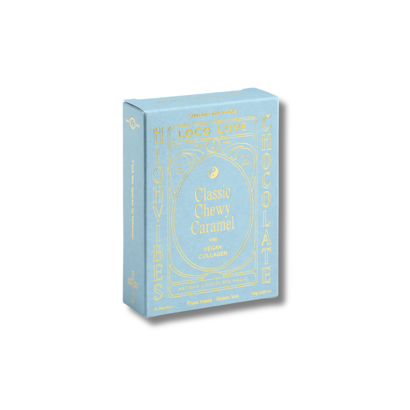 A light blue rectangular box of Loco Love Classic Chewy Caramel Vegan Chocolate, featuring gold foil lettering and decorative borders, set against a plain white background.