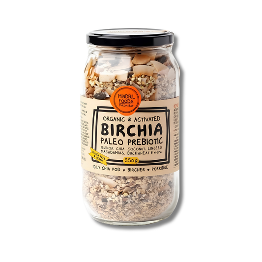 A glass jar of Minor Foods Paleo Prebiotic Birchia, containing a mix of oats, chia seeds, coconut flakes, and dried fruits, with a beige label and black lid, set against a plain white background.