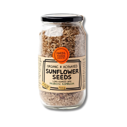 A 500g glass jar of Minor Foods Organic & Activated Sunflower Seeds, featuring a black lid and a beige label with an orange circular badge, set against a plain white background.