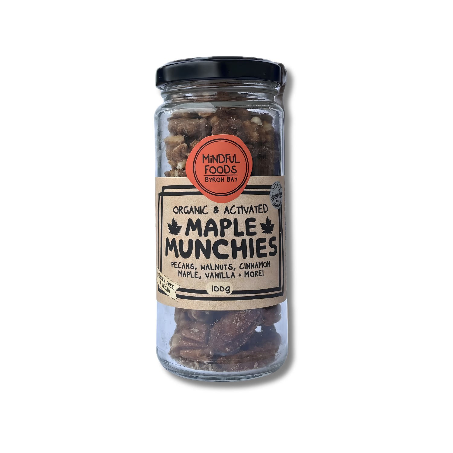 A 10oz glass jar of Mindful Foods Byron Bay Maple Munchies, containing pecans, walnuts, cinnamon, maple, vanilla, and more, with a black lid and a beige label.