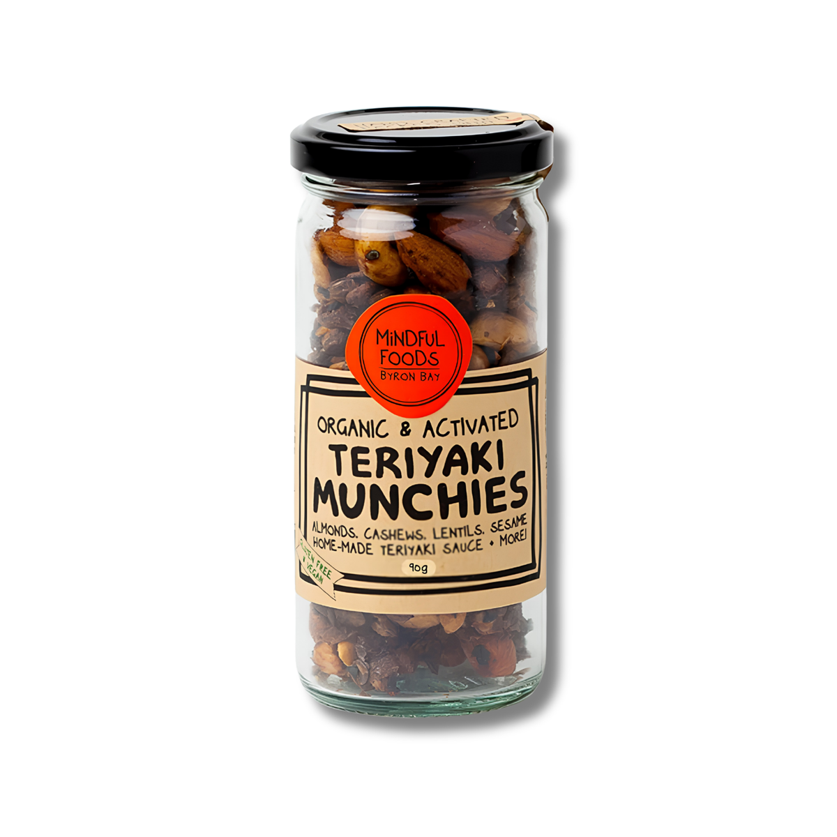 A glass jar of Mindful Foods Teriyaki Munchies on a white background. The jar contains a mixture of almonds, cashews, lentils, and seersalt, with a black lid and a beige label featuring a red circular logo.