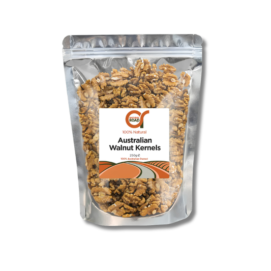A stand-up pouch of ROK6 Australian Walnut Kernels, showing the brown walnut pieces through a clear window in a silver resealable bag with a white and orange label.