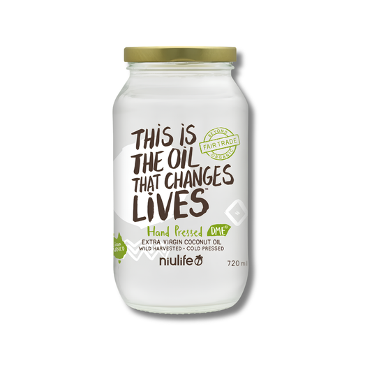 A glass jar of Nulife hand pressed extra virgin coconut oil with a gold metal lid and a white label featuring brown and green text.