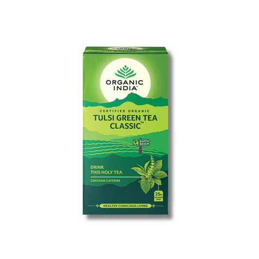 A box of Organic India Tulsi Green Tea Classic on a plain white background. The packaging is primarily green with a white circular logo area at the top, featuring the brand name 'Organic India' and product details including 'Certified Organic' and 'Tulsi Green Tea Classic'.