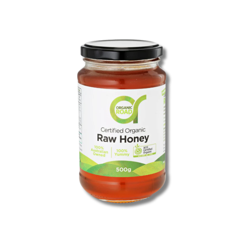 Jar of Organic Road raw honey on a white background