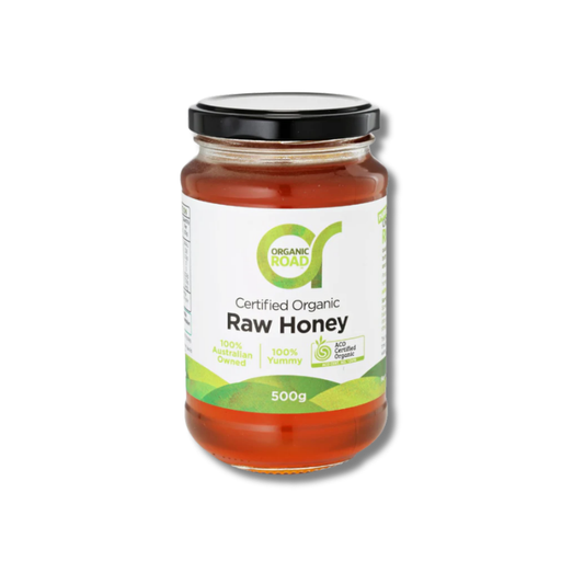 Jar of Organic Road raw honey on a white background