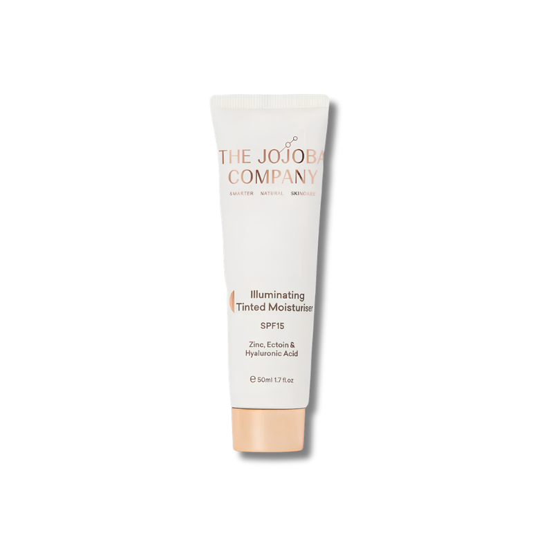 A single tube of The Jojoba Company Illuminating Tinted Moisturizer SPF 15, shown on a clean white background. The tube is white with peach-colored text and a peach-colored cap, with a soft shadow underneath.