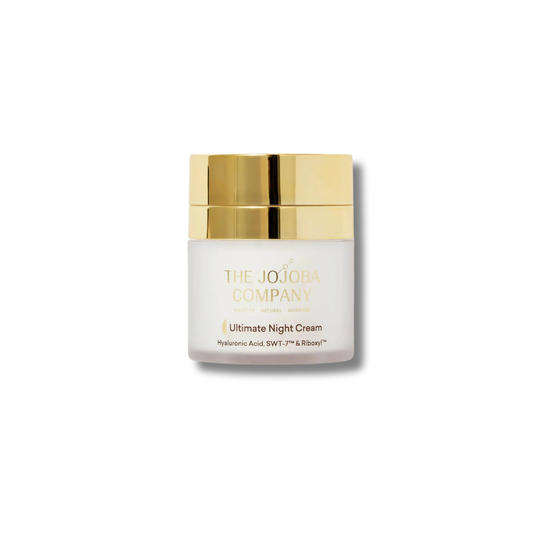 A jar of The Jojoba Company Ultimate Night Cream with a white body and a metallic gold cap, centered on a clean white background.