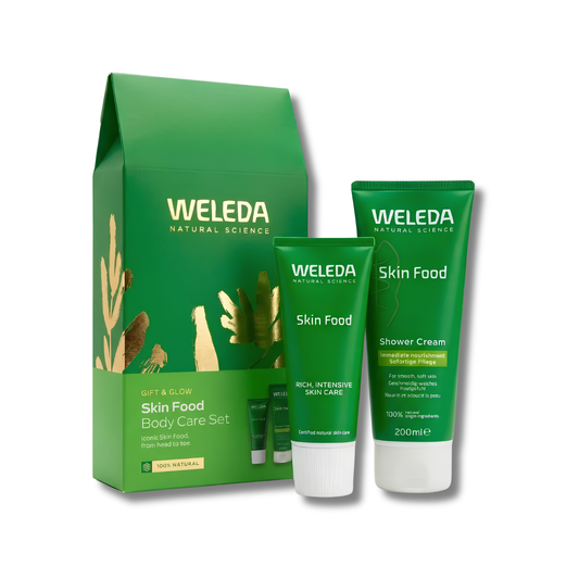Weleda Natural Science Gift & Glow Skin Food Body Care Set, featuring a green gift box, a green Skin Food tube, and a green Shower Cream tube with white caps, on a white background.